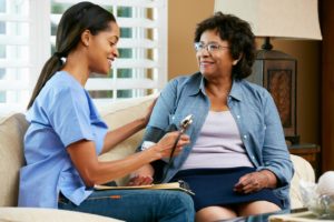 photo of nurse visiting senior female patient at home